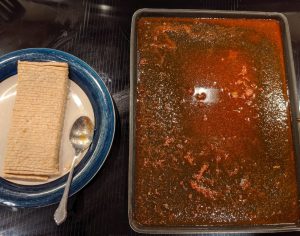 Sliced tempeh on the left; marinade spread on cookie sheet on the right. (I used salsa in the marinade, so it is a little bumpy.)