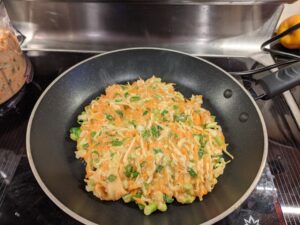 okonomiyaki cooking in frying pan